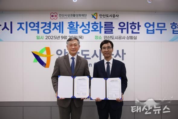 허숭 안산도시공사 사장(왼쪽)과 송해근 안산시상권활성화재단 대표이사(오른쪽)가 기념촬영을 하고 있다.(사진=안산도시공사 제공)